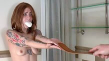 Naked hand strapping in bathtub